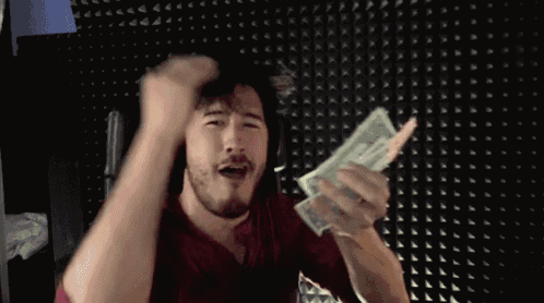a man is holding a stack of money in his hands
