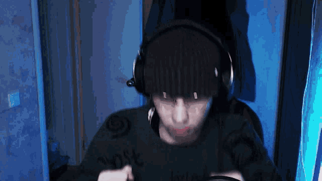 a man wearing headphones and a green shirt that says " lost " on it