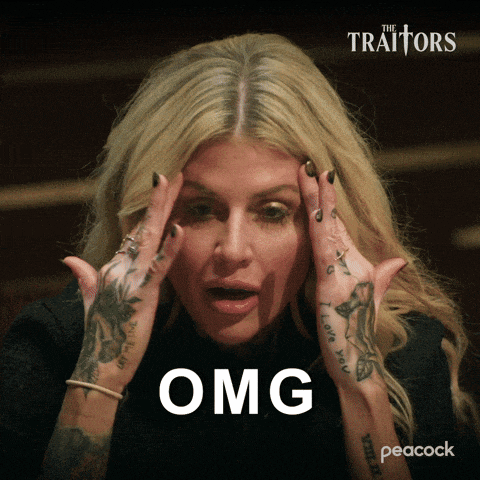 a woman with tattoos on her hands holds her head and says " omg "