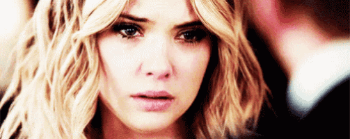 a close up of a woman 's face with a tear running down her face .