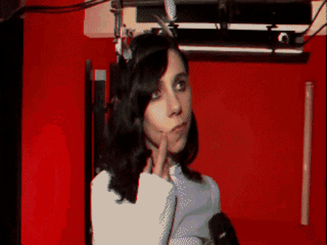 a pixelated image of a woman with a microphone in front of her