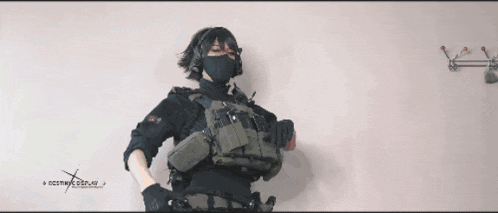 a woman is holding a gun in front of a sign that says ncsmwk.com.au