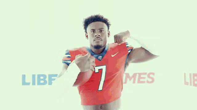 a man in a red nike jersey with the number 7 on it