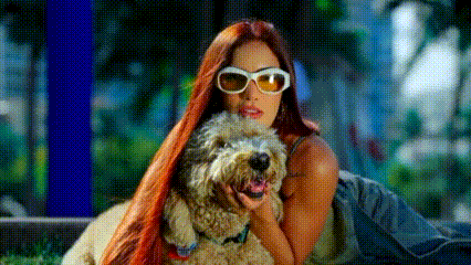 a woman with long red hair is laying down with a dog