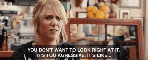 a woman is sitting at a table with a sign that says you don t want to look right at it