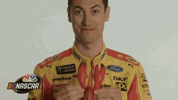 a man in a yellow and red ford shirt is holding a lobster
