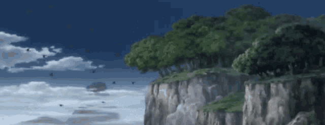 a cliff with trees on it and birds flying overhead