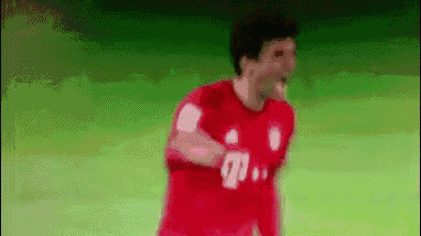 a soccer player in a red jersey is running on a field .