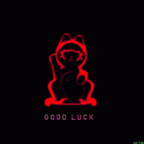 a green cat with the words `` good luck '' written below it .