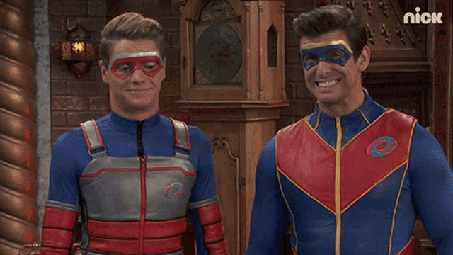 two men in superhero costumes are standing next to each other in front of a clock that says nick