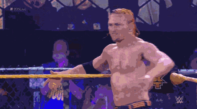 a man in a wrestling ring with the letters x on his pants