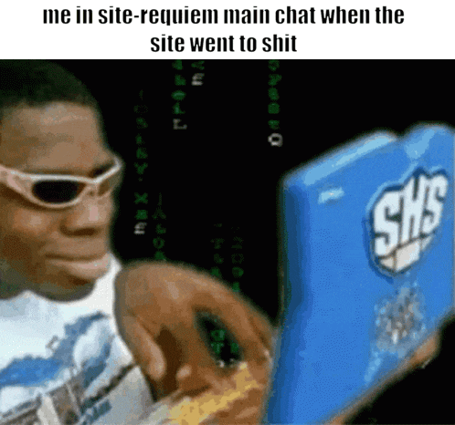 a man wearing sunglasses is looking at a blue shs computer