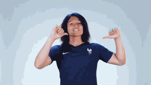 a woman wearing a blue shirt with a rooster on it