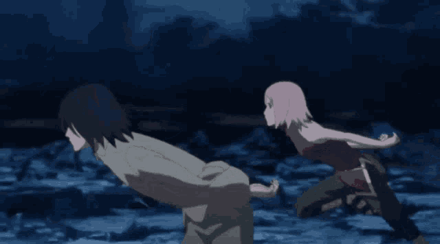 a man and a woman are running in a dark area