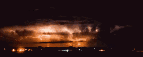 lightning strikes in the night sky over a lake