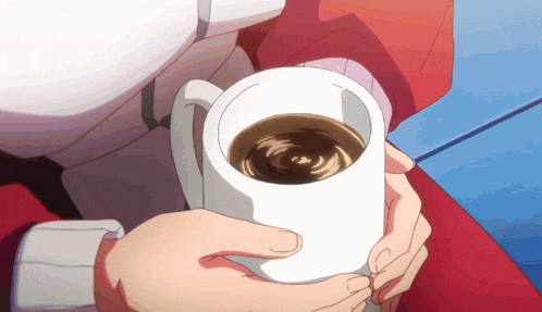 a person holding a cup of coffee in their hand
