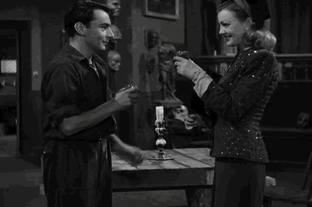 a man and a woman toasting with wine glasses