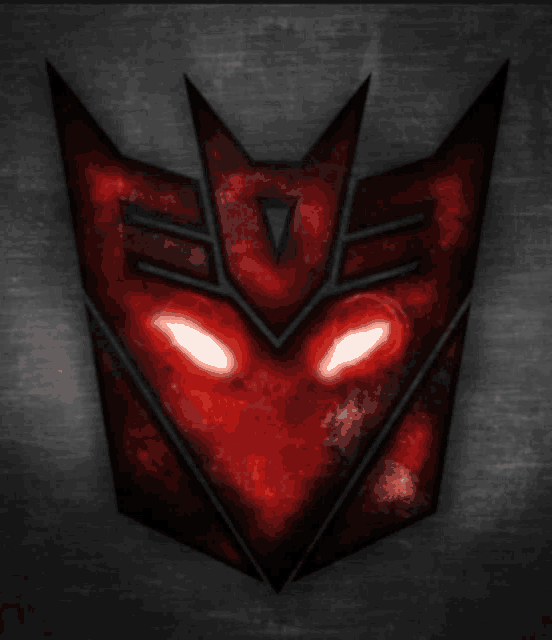 a red and black transformer logo with glowing red eyes