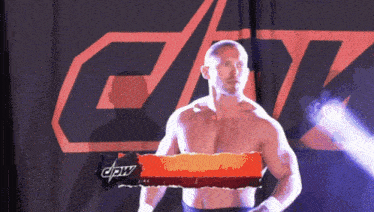 a wrestler is standing in front of a sign that says cpw