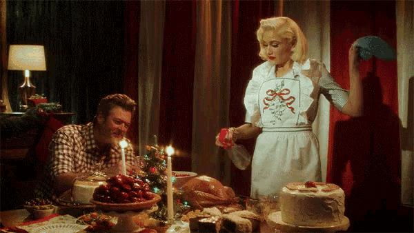 a man and a woman are sitting at a table with food