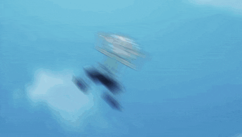 a person is falling into the water while holding onto a rope .