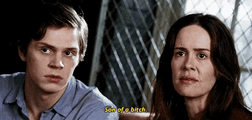 a man and a woman are sitting next to each other and the man is saying son of a bitch