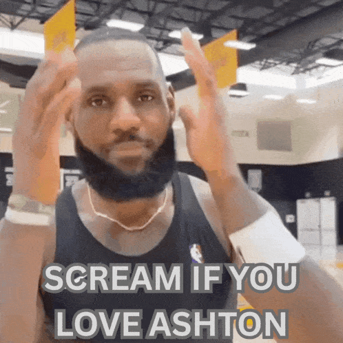 a man with a beard is screaming that he loves ashton