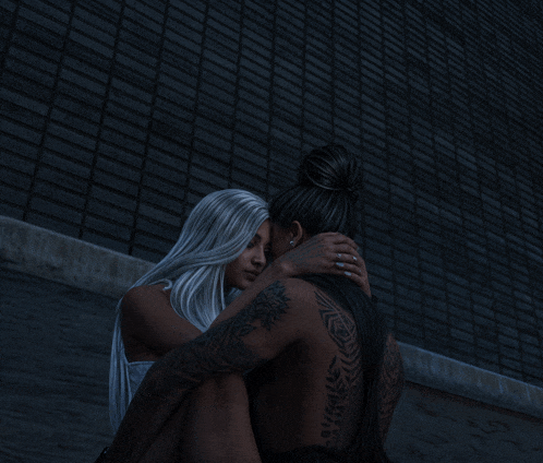 a man and a woman are hugging each other in front of a brick wall