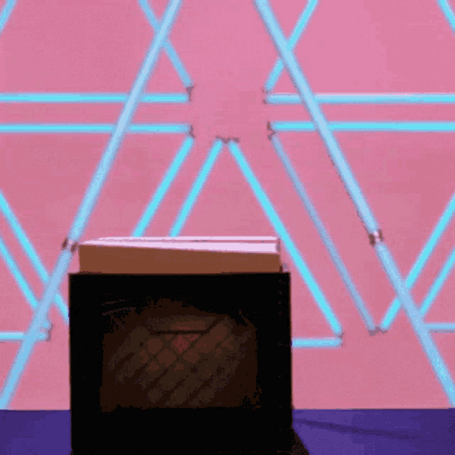 a book is sitting on a table in front of a pink and blue background