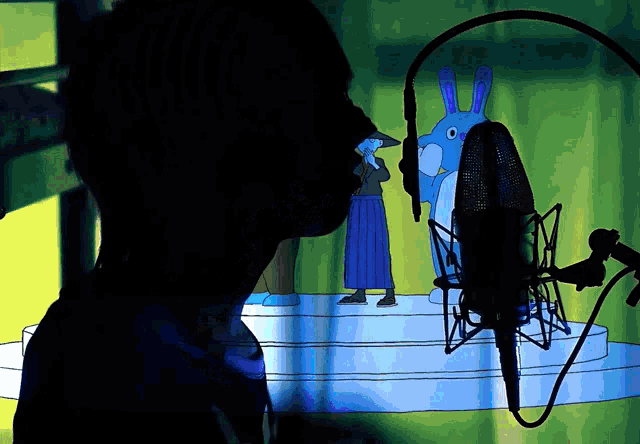 a person is singing into a microphone in front of a cartoon character