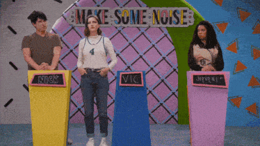 a group of people standing in front of a sign that says make some noise