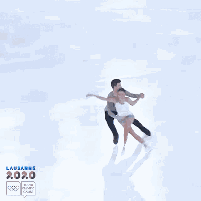 a man is holding a woman 's hand while ice skating at the lausanne 2020 youth olympics