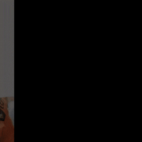 a close up of a man wearing an orange jacket that says cisco on it