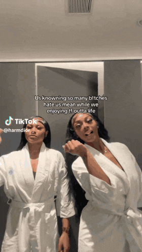 two women in white robes standing next to each other with a tiktok written below them