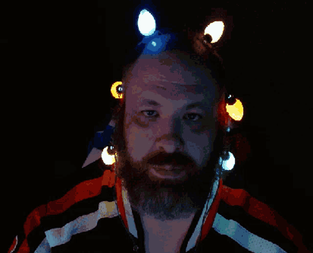 a man with a beard is wearing a red white and blue jacket