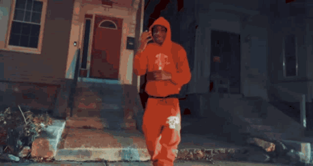 a person wearing a red hoodie with a white logo on it