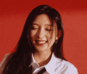 a close up of a woman wearing a white shirt and tie