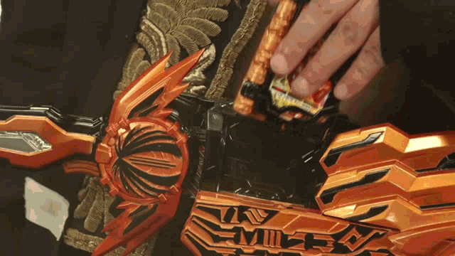 a close up of a person holding a toy that says ' nv ' on it