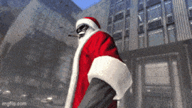a man in a santa suit is standing in front of a building