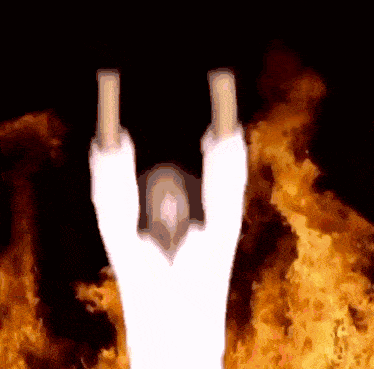 a person giving the middle finger in front of a fire background