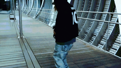 a person wearing a black hoodie with the number 10 on it
