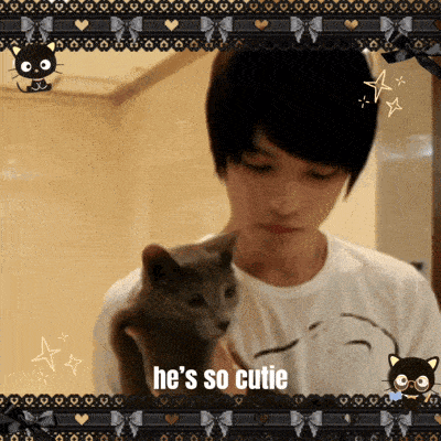 a man holding a cat that says he 's so cutie on the bottom