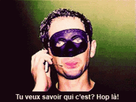 a man in a mask talking on a cell phone
