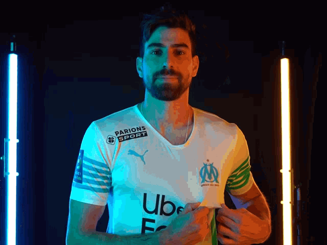 a man with a beard is wearing a white shirt with uber written on it