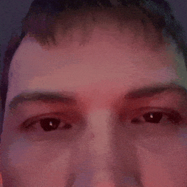 a close up of a man 's face with a red background .