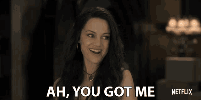 a woman is smiling and says ah you got me netflix