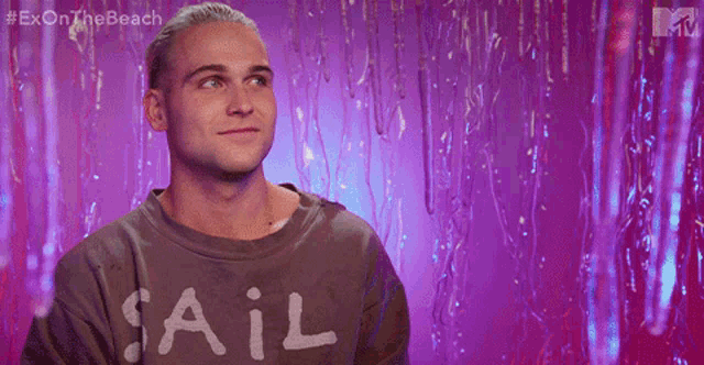a man with blonde hair is wearing a sweater that says jakk
