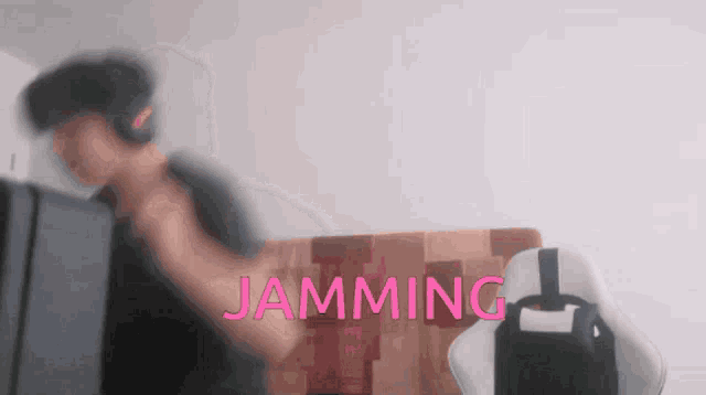 a blurry image of a person with the word jamming in pink letters