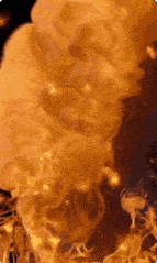 a close up of a fire with smoke coming out of it on a black background