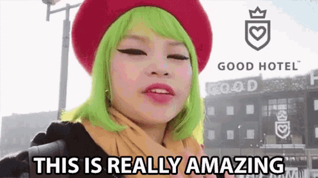 a woman with green hair is wearing a red beret and scarf and says this is really amazing